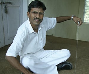 Laxman Ghole at work on his charkha.