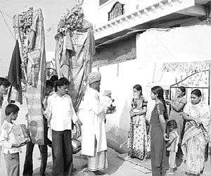 Devotees being offered vibhudi at a Muharram procession in Karimnagar on Monday.
