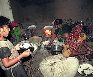 Women members of the family busy in the kitchen.