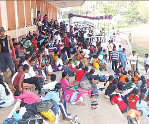 ROOFLESS: Athletes from various schools across the State resting on the steps of the pavilion at Anna Stadium, Nagercoil.