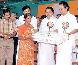 Local Administration Minister M K Stalin distributing free stove to a beneficiary during the inauguration of Tirupur district on Sunday.