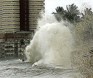 A huge wave hits the safety wall of the buildings along the sea shore during high tide in Mumbai. (Photo: AP)