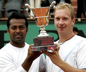 Leander Paes and Lukas Dlouhy hold the trophy after defeating Wesley Moodie and Dick Norman in the men's doubles final of the French Open. (AP)
