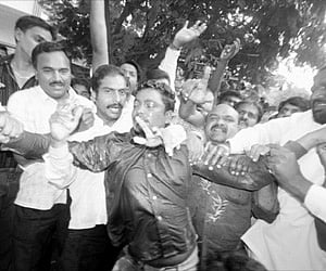Congress activists trying to dissuade a party worker who attempted suicide by dousing himself in kerosene near PCC president D Srinivas’s residence in