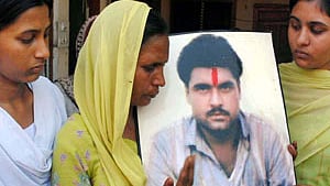 Poonam and Swapandeep, daughters of Sarabjit Singh, with mother Sukhpreet Kaur at village Bhikhiwind near Amritsar. 