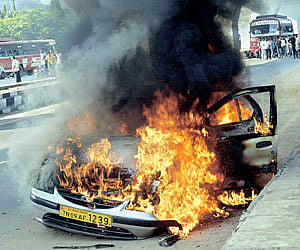 INFERNO: An air-conditioned Indica that caught fire on GST Road, in the city on Monday