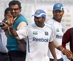 Sri Lankan spin bowler Muttiah Muralitharan waves at Indian cricketer Sachin tendulkar not seen in the picture on Monday. PTI