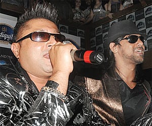 Tarsame Singh Saini (left) performs with a member of his band.