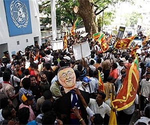 Sri Lankan protesters wave their national flags and block the entrance of the UN office in Colombo recently. (AP)