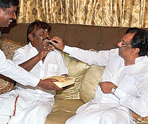 Senior Congress leader EVKS Elangovan gives sweets to DMDK leader Vijayakanth on his birthday on Wednesday. (EPS)