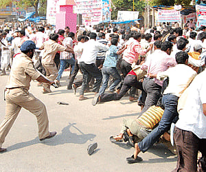 Rising violence: Police caned and dispersed the mob of Telangana activists who attacked buses in Nalgonda district on Monday. | Express Photo