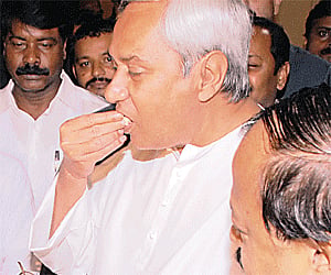 Chief Minister Naveen Patnaik sharing sweets with colleagues in Bhubaneswar on Friday, after the State’s name was changed from Orissa to Odisha |  EPS
