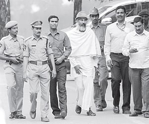 Bharat Bhai (middle), accused in Mecca Masjid blast case, coming out of Nampally court after being produced by NIA officials in Hyderabad on Saturday.