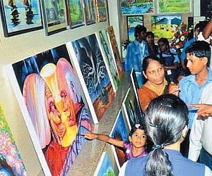 FOR THE LOVE OF MOTHER EARTH: Visitors admiring the work of the children of SBOA School & Junior College, Anna Nagar, at ‘Environex 2011’ an arts and