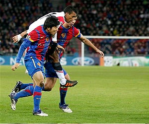 Manchester United's Nani fights for the ball with Basel's Joo Ho Park and Basel's Fabian Frei during their Champions League Group C soccer match. (AP)