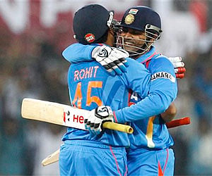 Sharma hugs Sehwag to congratulate him on scoring double century and world record one-day score in 4th ODI against West Indies, Indore, Thursday. AP