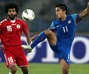 Indian striker Sunil Chettri controls the ball as Afghanistan players look on during the final match of the SAFF championship in New Delhi. PTI