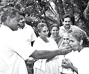 Sharmi’s family members distributing sweets at her house in Balal grama panchayat in Kasargod on Friday.