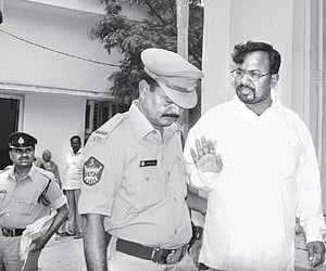 Mallela Om Prakesh being escorted to the court in Anantapur on Wednesday. ENS