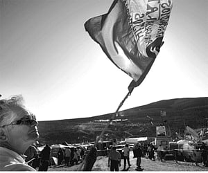 A man waves a Chilean flag while he awaits the rescue of 33 trapped miners out of the San Jose mine, near Copiapo, Chile on Wednesday | AFP