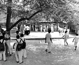 (Above) Students throng the canteen to have their mid-day meal on Wednesday.  (Left) The gap in the compound wall on the north-eastern side of the sch