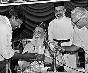 Mar Thoma Valia Metropolitha Philipose Mar Chrysostom releasing the brochure of Centre for the Study of Religion and Society with C P Mathew Chair to