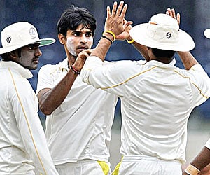Jagannathan Kaushik (2nd left) took 28 wickets in his debut Ranji season.