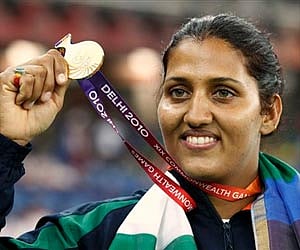 Krishna Poonia poses with her gold medal for the Women's Discus during the Commonwealth Games. AP