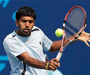 India's Rohan Machanda Bopanna returns a ball against Uganda's Robert Buyinza during their men's singles match at the Commonwealth Games. AP