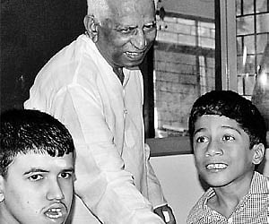 File photo of G Muniratnam (centre) along with differently-abled children