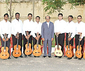 The Madras Guitar Ensemble with their guitars pose for a photograph