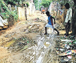 WHAT A MESS!  A boy tries to cross a dirty road in Gandhi Nagar, Pattabiram. D Sampathkumar