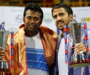 Leander Paes, left, and his partner Serbia's Janko Tipsarevic pose with the trophies after their win in the doubles final match. AP