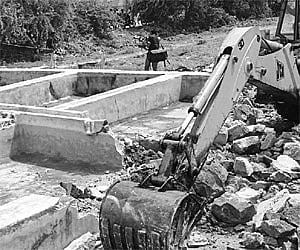 out of way: Earthmovers dismantling illegal dyeing units in Erode on Friday | Express Photo