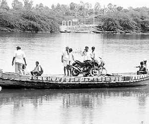 Villagers travelling in a country boat through Upputeru to reach Chinnagollapalem village in Krishna district.