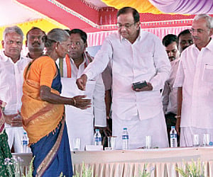Union Home Minister P Chidambaram (third from R) handing over the keys of a house to a beneficiary at a function in Puducherry on Sunday.