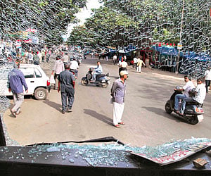 Telangana activists damaged RTC buses after an Adilabad youth Srinivas climbed atop a hoarding at Koti in Hyderabad on Thursday, threatening to jump a