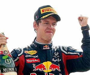 Red Bull driver Sebastian Vettel, of Germany, celebrates on the podium after winning the Italian Formula One Grand Prix at the Monza racetrack. AP