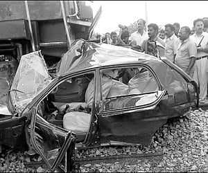 The mangled remains of the car which was hit by a train at a level crossing near Kurnool on Tuesday | express Photo