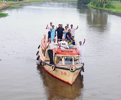 Members of the Voice of Nature work to clean the Kodoor off Kottayam. B P Deepu