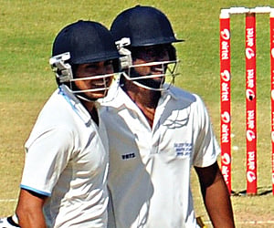 Double centurion Manish Pandey (left) of Karnataka and cenutrion Abhinav Mukund of Tamil Nadu celebrate during their 174-run stand for the third wicke