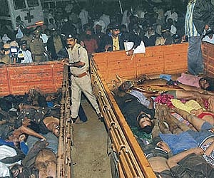 Dead bodies being transported from the spot in Pullumedu after the disaster. (Photo: PTI)