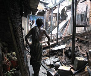 A vendor stares at the remains of the shops |Kaviyoor Santhosh