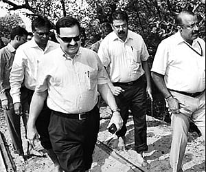 District in-charge Secretary Vittalmurthy and other officials walking through mangroves in Kali island.