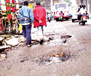 The landscape of CMH Road is dented with a number of potholes | express photo