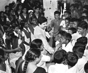 Magician Gopinath Muthukad being greeted by the students of Government City Vocational Higher Secondary School on Monday.