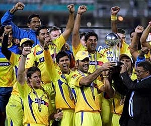 Chennai Super Kings captain Dhoni, center pose with teammates after winning the final of Champions League T20 cricket match in Johannesburg. AP