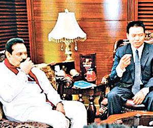 Chinese women wearing saree serving tea to the visiting Sri Lankan President Mahinda Rajapaksa and others at the Foreign Studies University in Beijing