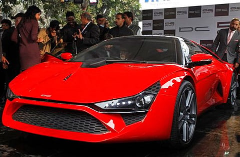 Actor Amitabh Bachchan sits inside DC Avanti, a sports car designed by DC Design at the India Auto Expo in New Delhi. APHyundai Veloster at the India Auto Expo. APActor John Abraham poses with a Yamaha Scooter Prototype model. APModels unveil Volkswagen'