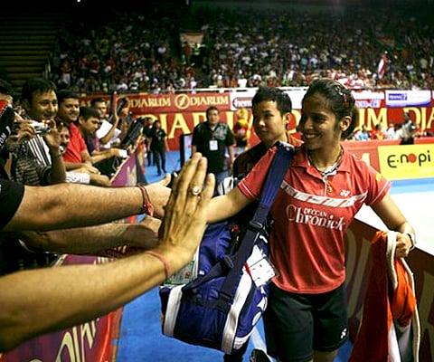 Saina Nehwal is greeted by supporters following her victory of the women's final over Sayaka Sato of Japan at the Indonesia Open Badminton Super Series. (AP)